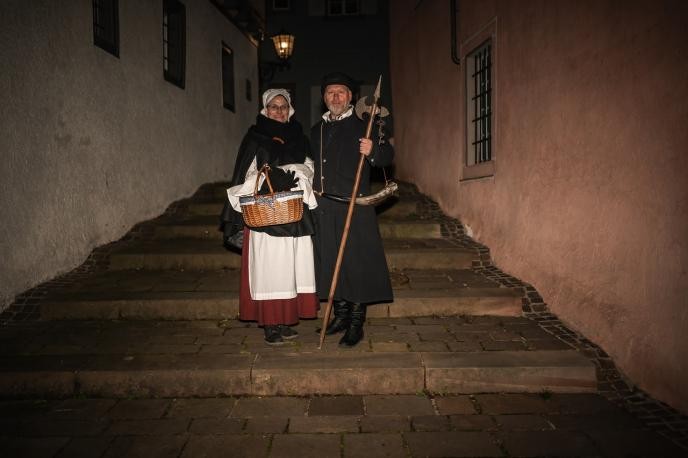 Nachtwächter und Bürgersfrau in historischen Kostümen in der Altstadt